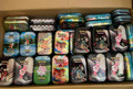 A box full of assorted official Pokémon mini tins ready to be packed as mystery tins